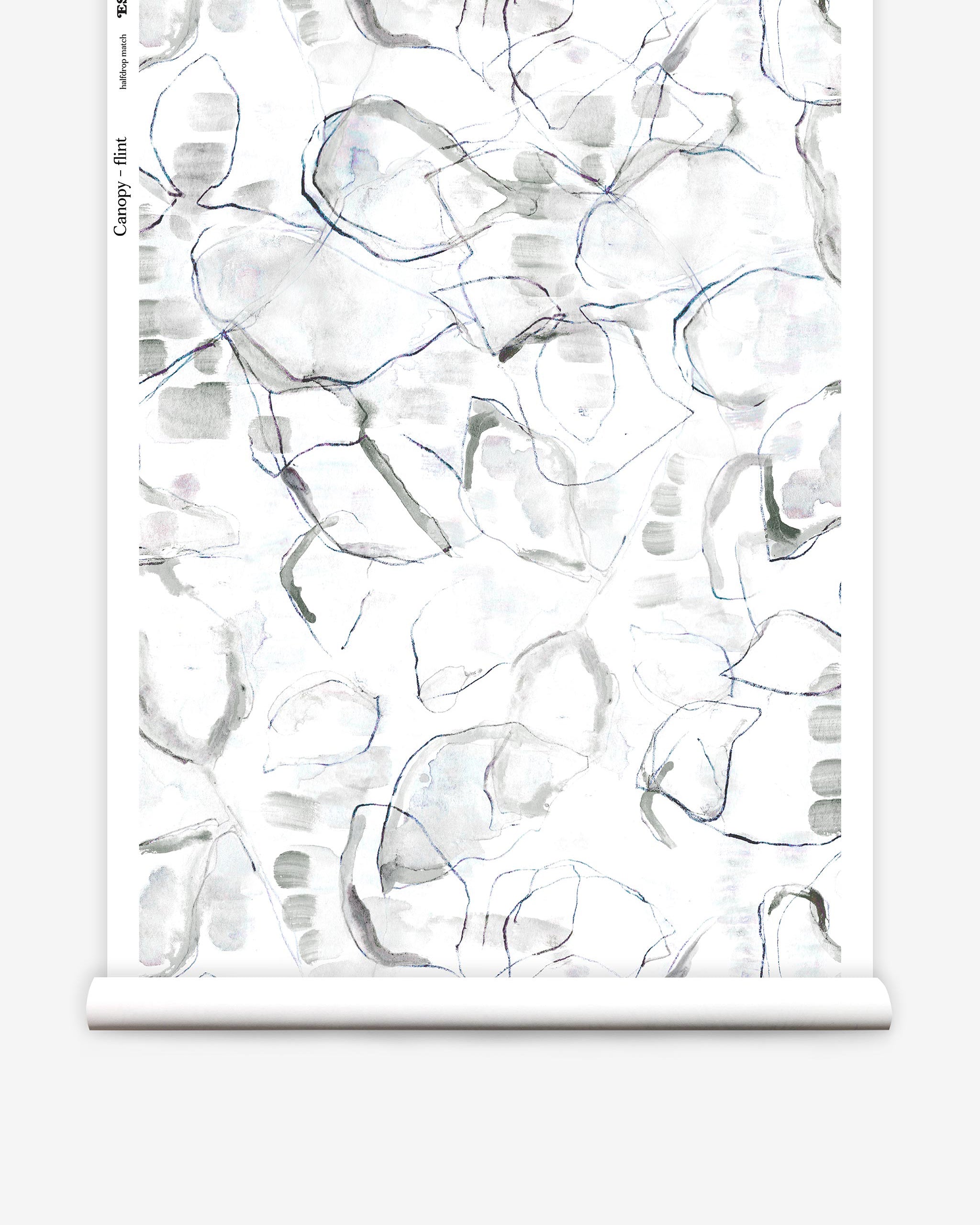 Partially unrolled wallpaper yardage in a watercolor painterly print in shades of gray, purple and cream.