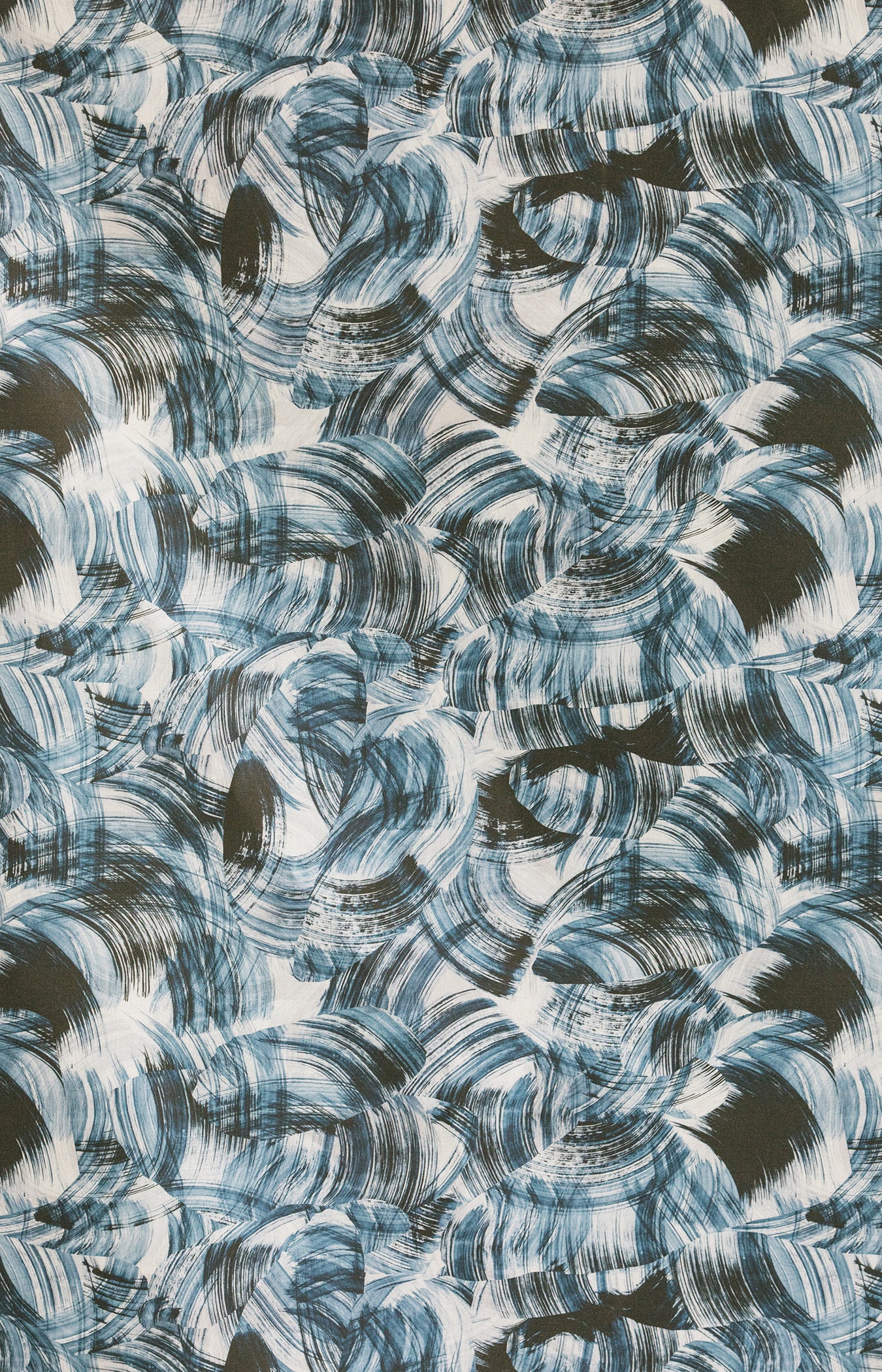 Detail of fabric in an absract paint swatch print in black and navy on a white field.