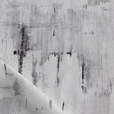Detail of fabric in a watercolor paint blot print in black and gray on a white field.