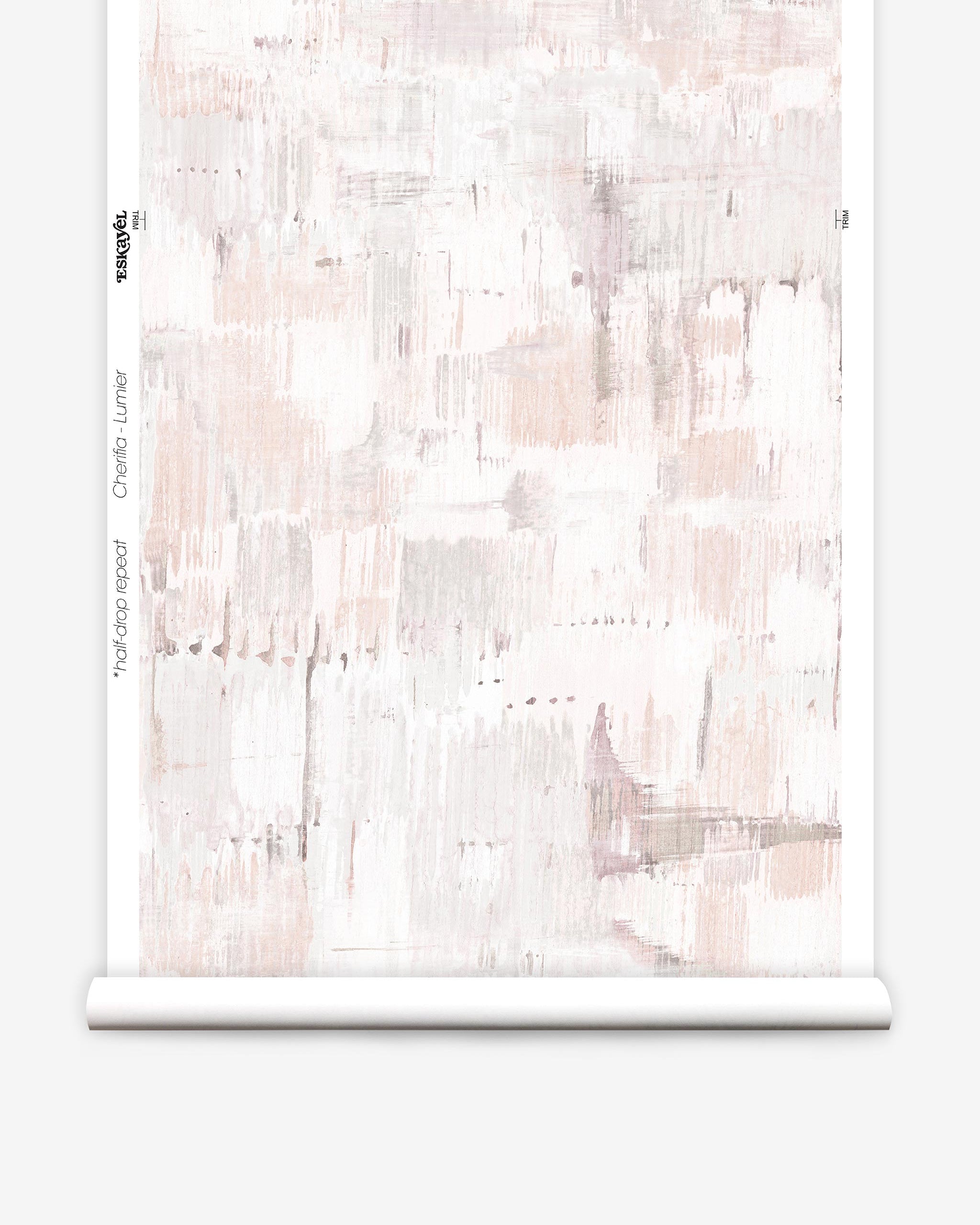 Partially unrolled wallpaper yardage in a watercolor textural print in shades of pink, cream and tan.