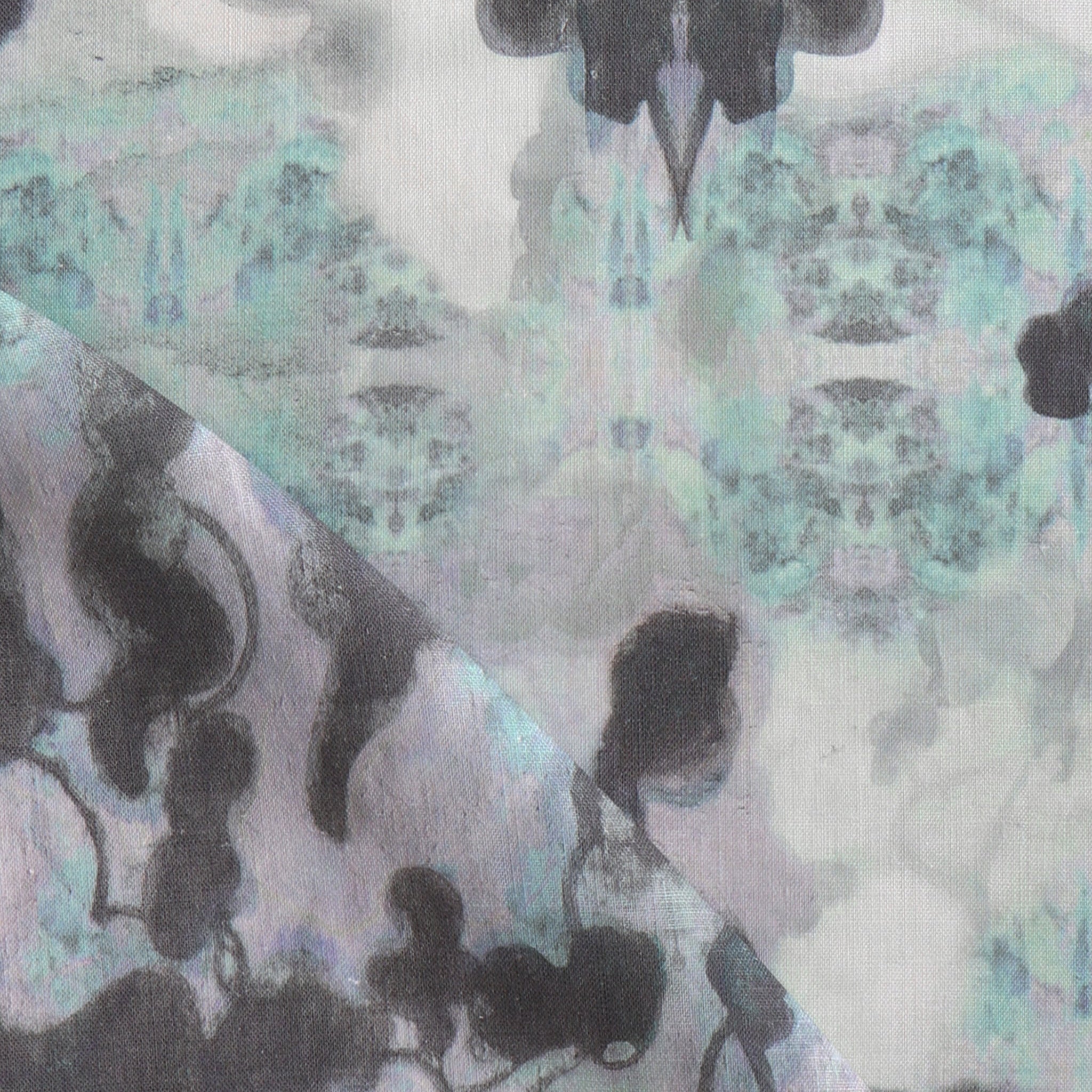 Detail of fabric in a watercolor tree print in shades of purple, turquoise and gray on a white field.