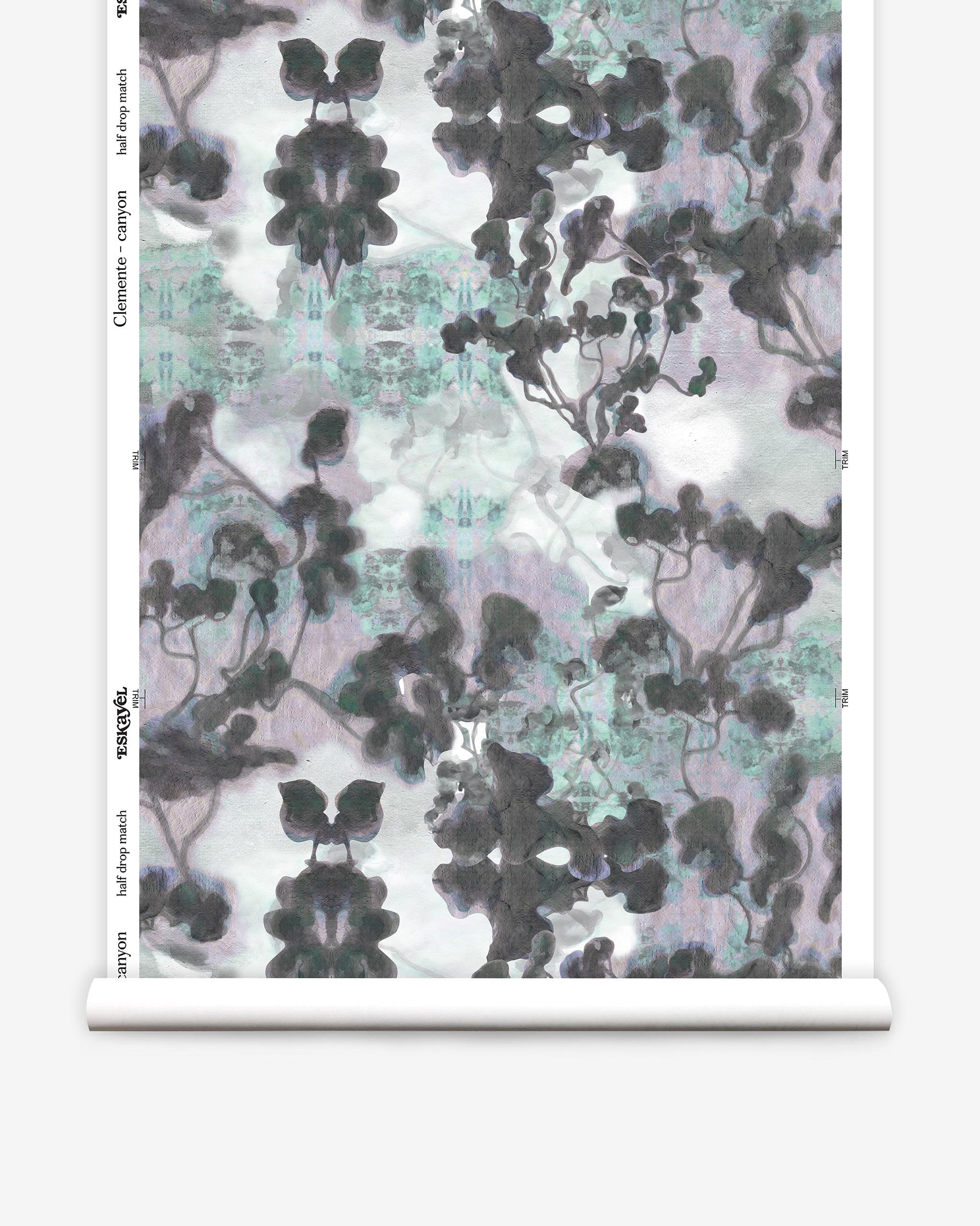 Partially unrolled wallpaper yardage in a watercolor tree print in gray, turquoise, purple and white.