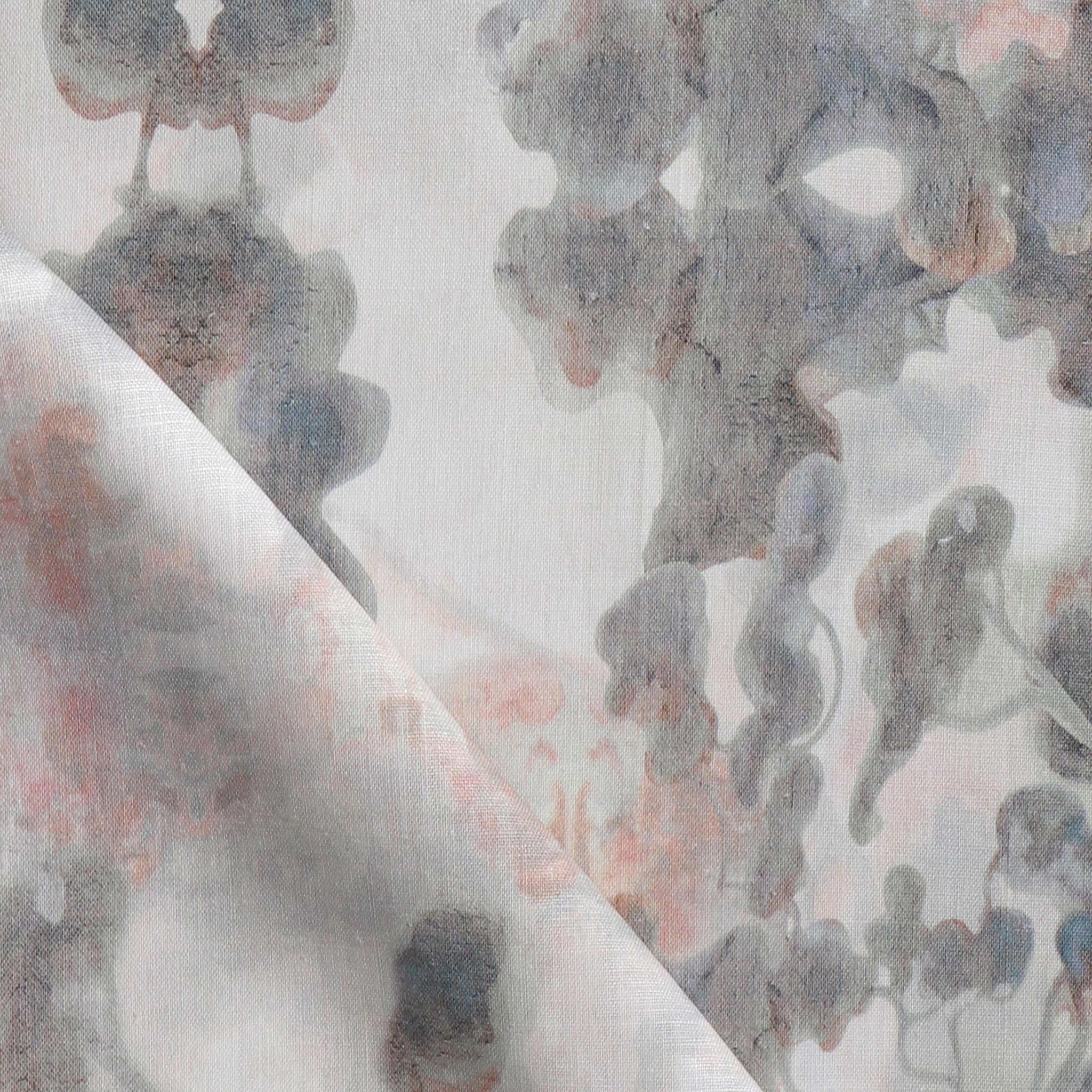 Detail of fabric in a watercolor tree print in shades of pink and gray on a greige field.