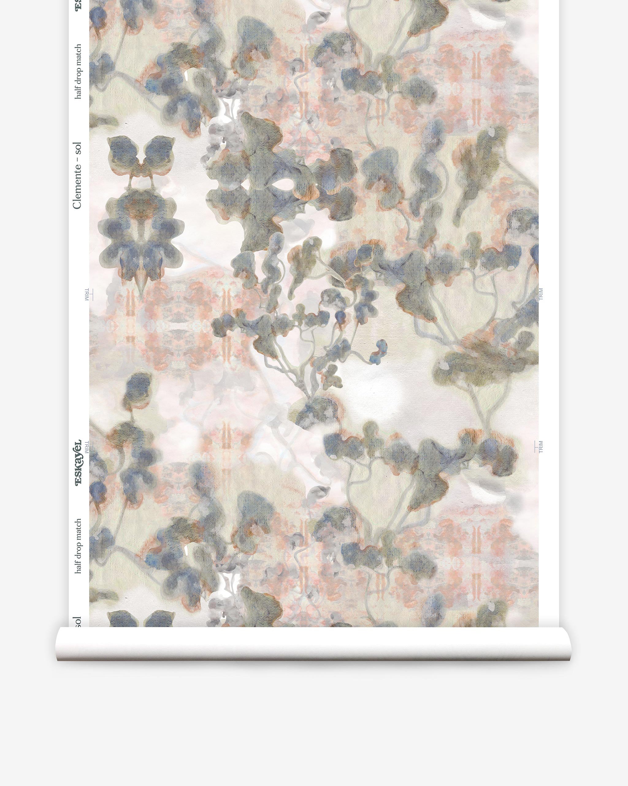 Partially unrolled wallpaper yardage in a watercolor tree print in gray, peach, tan and white.
