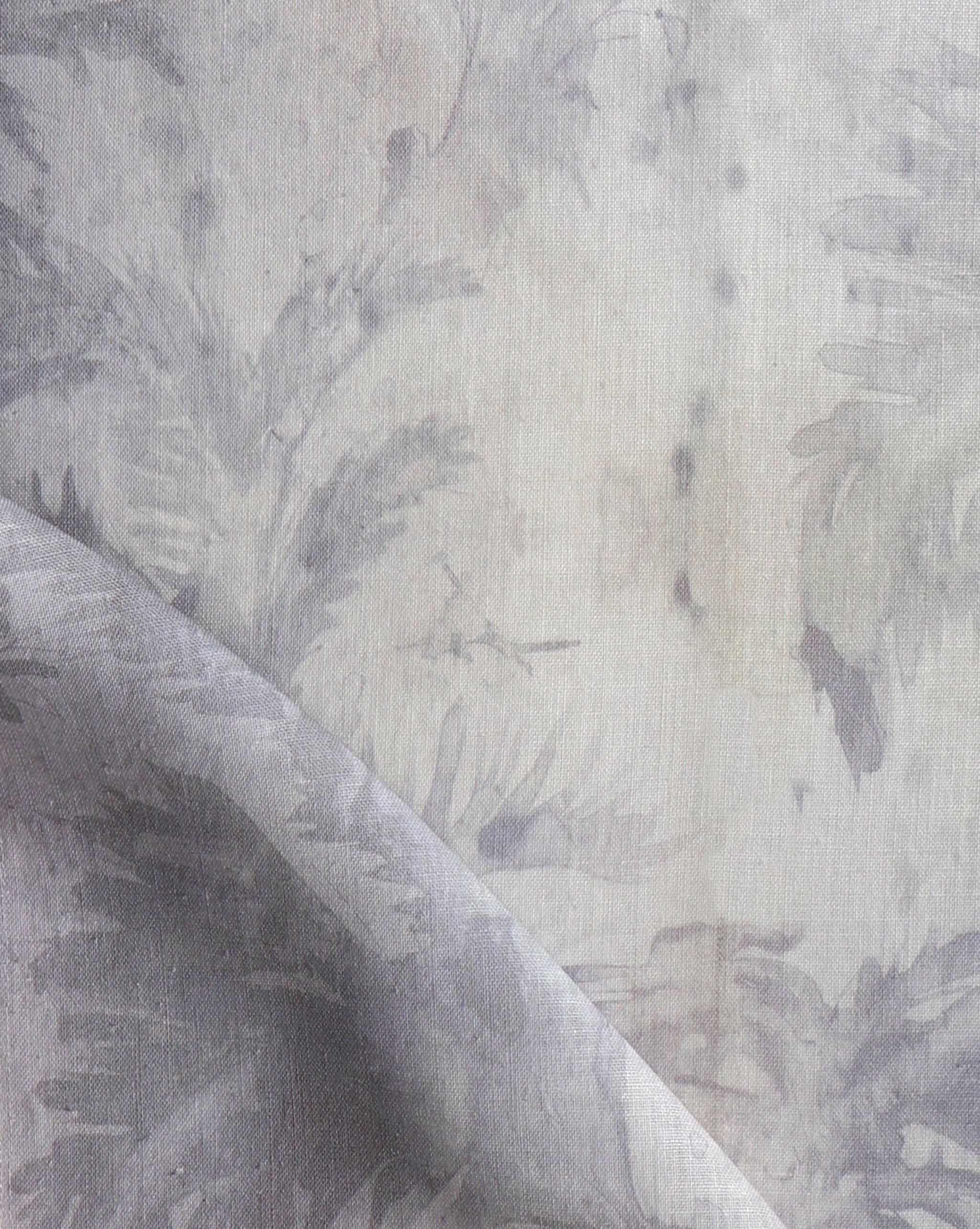 Detail of fabric in a painterly palm leaf print in shades of purple on a greige field.