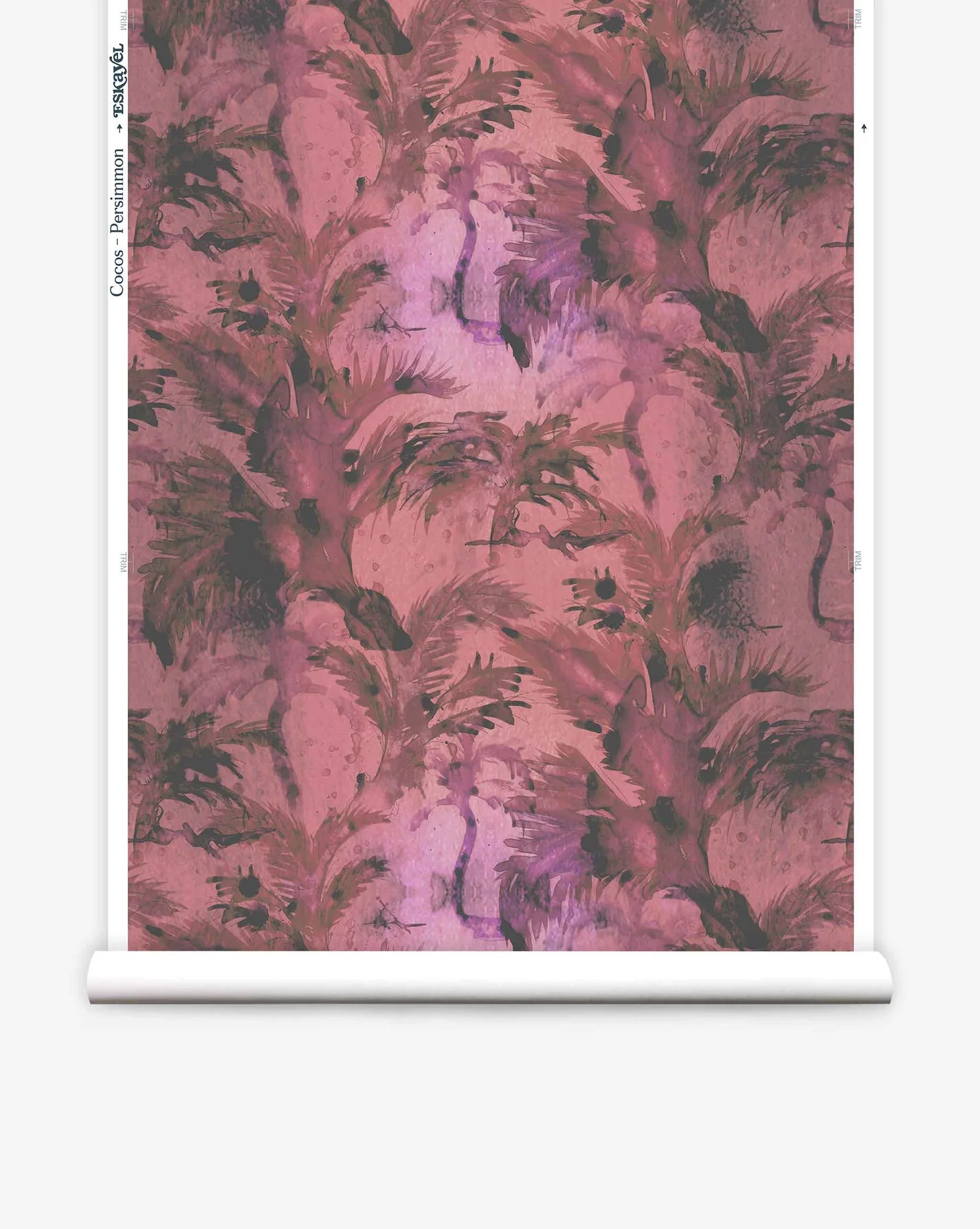 Partially unrolled wallpaper yardage in a painterly palm tree print in shades of red, pink and gray.