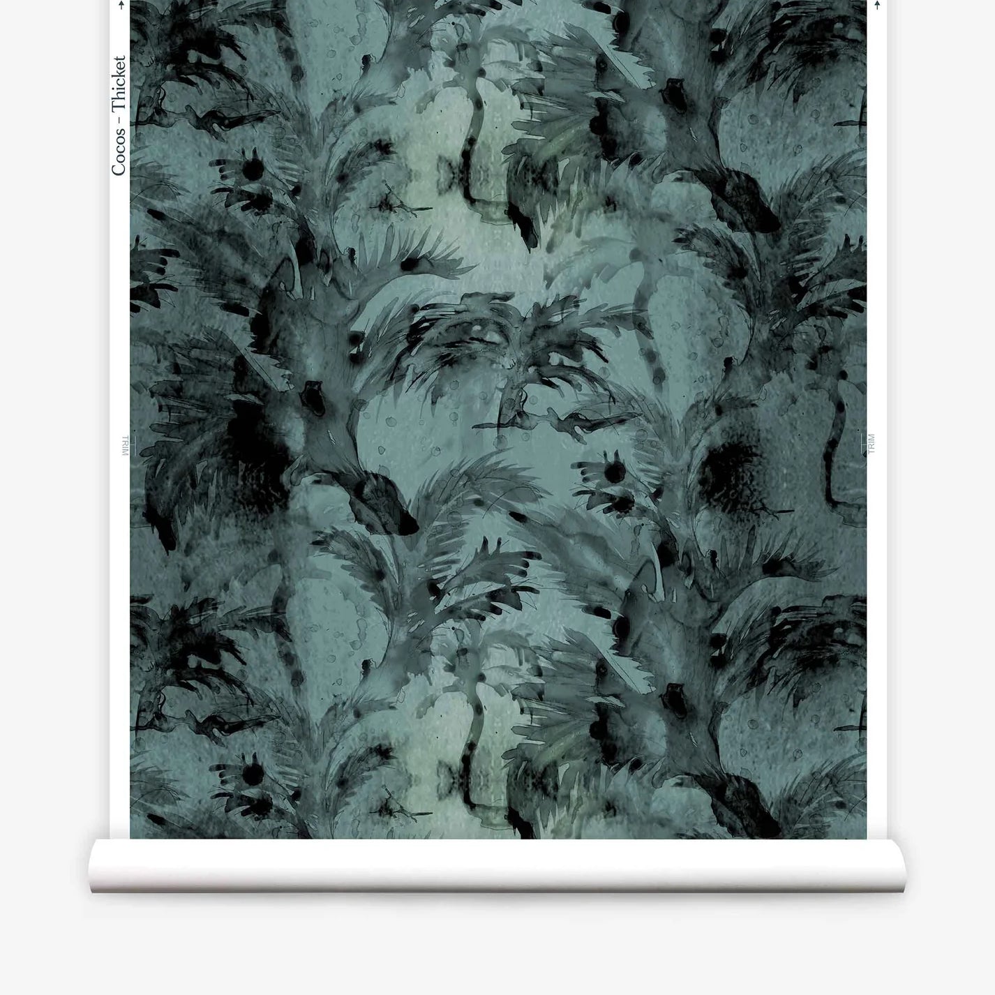 Partially unrolled wallpaper yardage in a painterly palm tree print in shades of gray and turquoise.