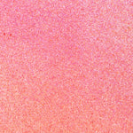 Close up of paint splatters in pink and orange.