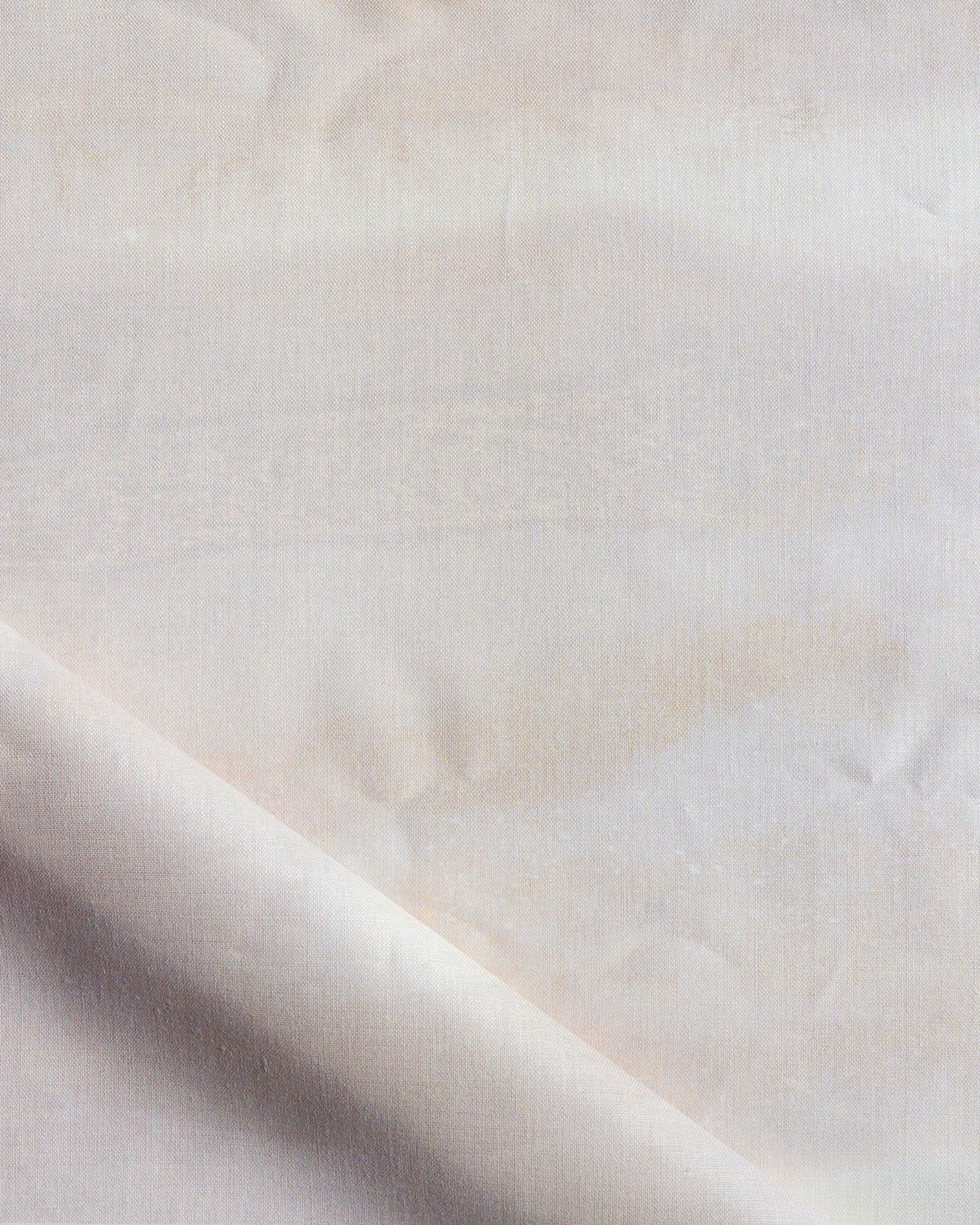 Close-up of a textured white fabric with a subtle pattern