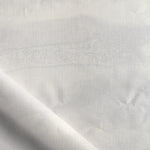 Close-up of white fabric with subtle texture