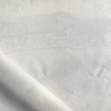 Close-up of white fabric with subtle texture