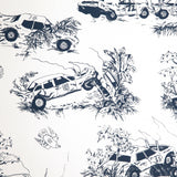 Detail of wallpaper in a playful illustrated car crash print in navy on a white field.