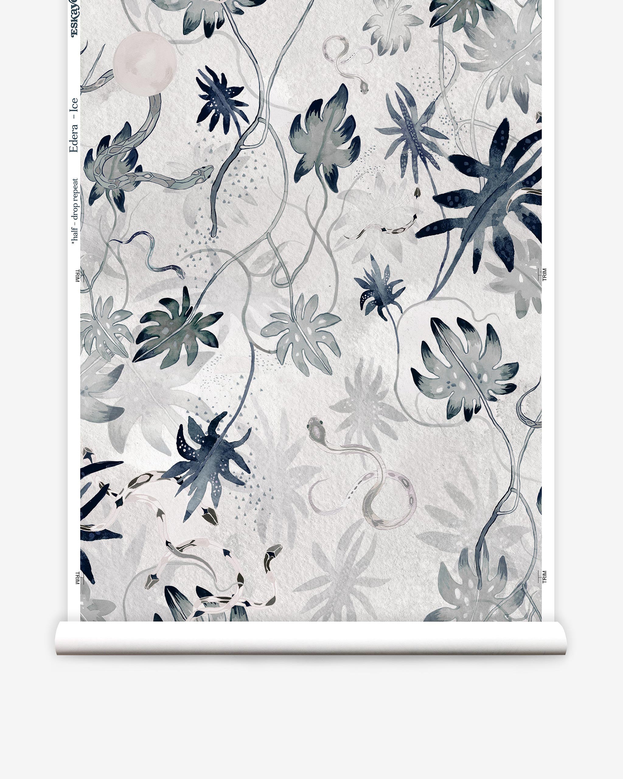 Partially unrolled wallpaper yardage in a playful leaf and snake print in gray and navy on a cream field.
