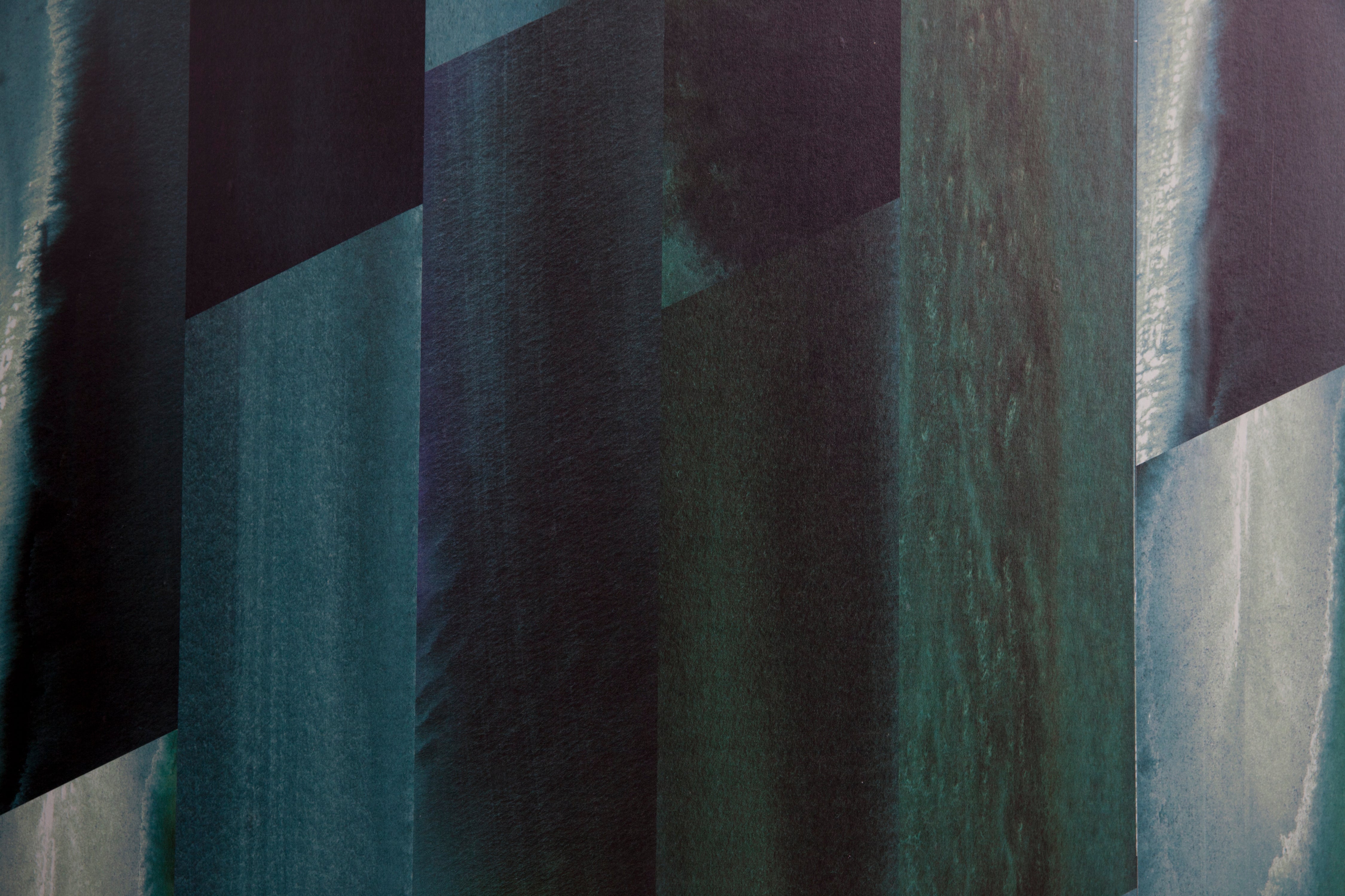 Detail of wallpaper in a linear geometric print in shades of black, blue and turquoise.