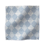 Square fabric swatch in a textural diamond print in light blue and white.
