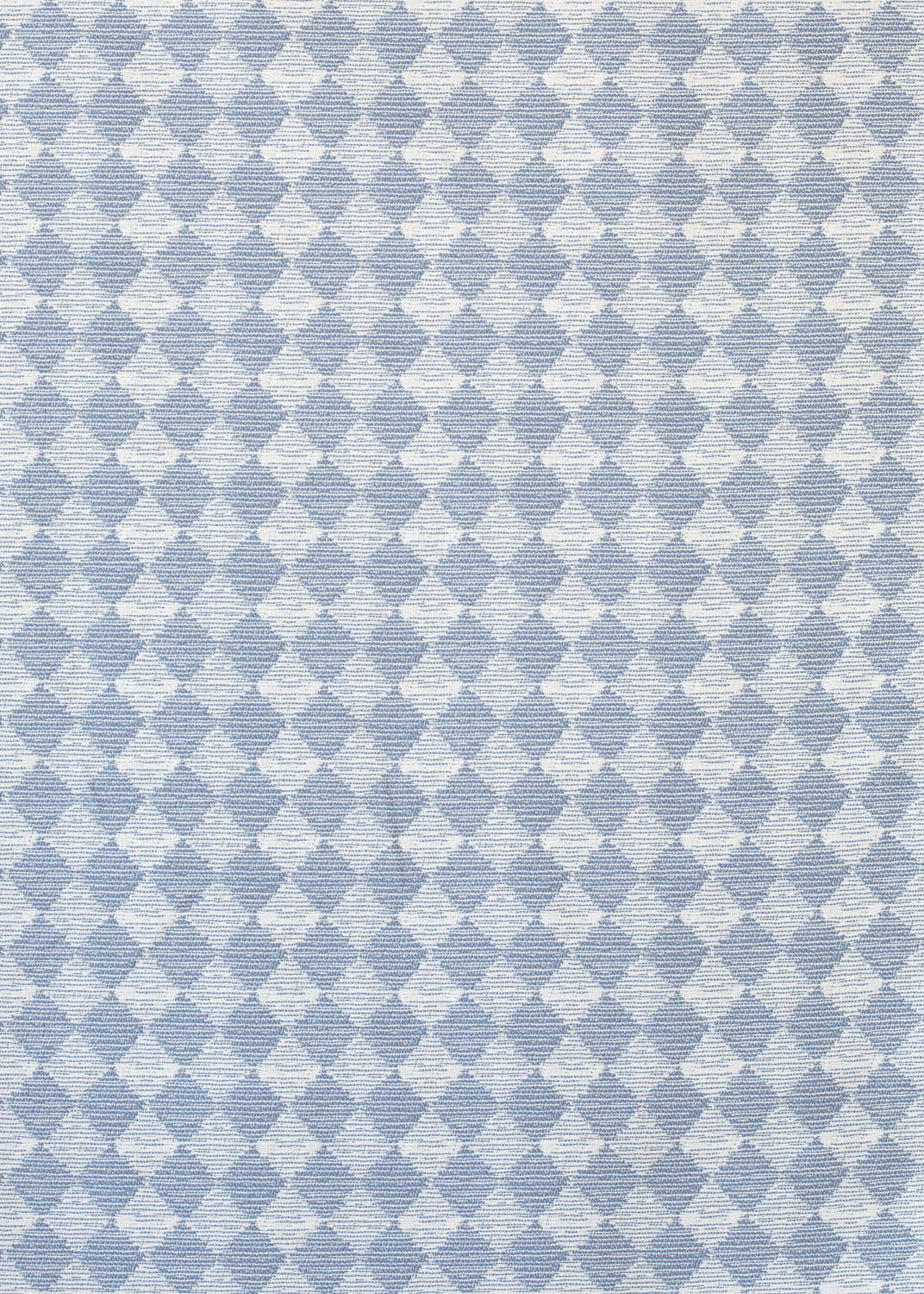 Detail of fabric in a textural diamond print in light blue and white.