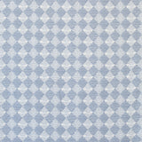 Detail of fabric in a textural diamond print in light blue and white.