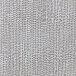 Detail of fabric in a painterly dotted print in gray on a light gray field.