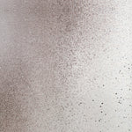 Detail of fabric in an abstract ombré paint splatter print in shades of gray and white.