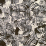 Detail of wallpaper in an abstract paint swatch print in black on a white field.