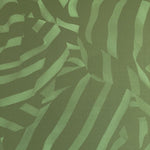 Detail of wallpaper in a playful broken stripe print in dark green on a green field.