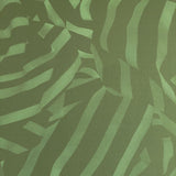 Detail of wallpaper in a playful broken stripe print in dark green on a green field.
