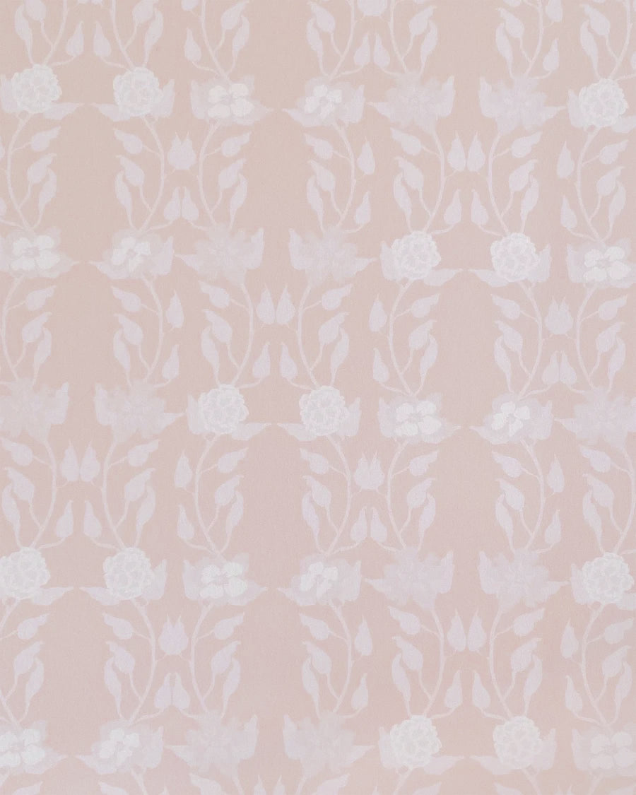 Detail of wallpaper in a linear floral print in white and cream on a light pink field.
