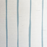 Detail of fabric in a playful irregular stripe print in blue on a cream field.