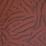 Detail of wallpaper in a playful broken stripe print in purple on a red field.