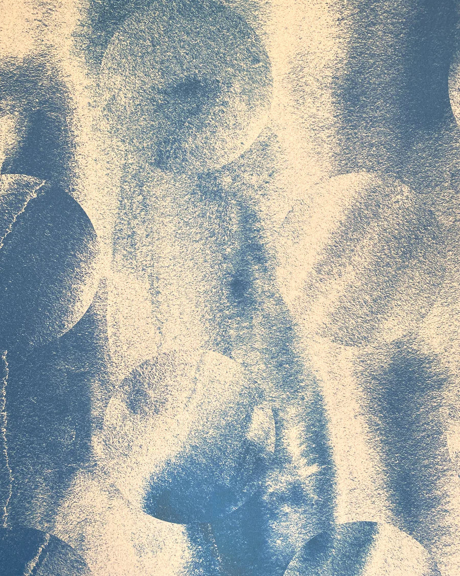 Detail of wallpaper in an abstract curvilinear pattern in mottled blue and tan.