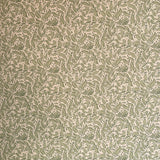 Detail of wallpaper in a painterly leaf print in olive and black on a cream field.