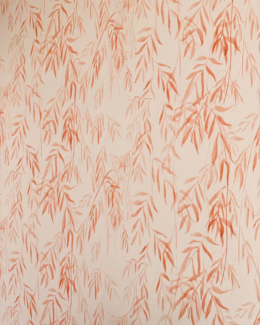 Detail of wallpaper in a painterly willow leaf print in coral on a cream field.