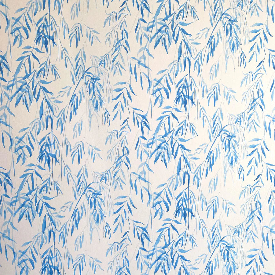 Detail of wallpaper in a painterly willow leaf print in blue on a white field.