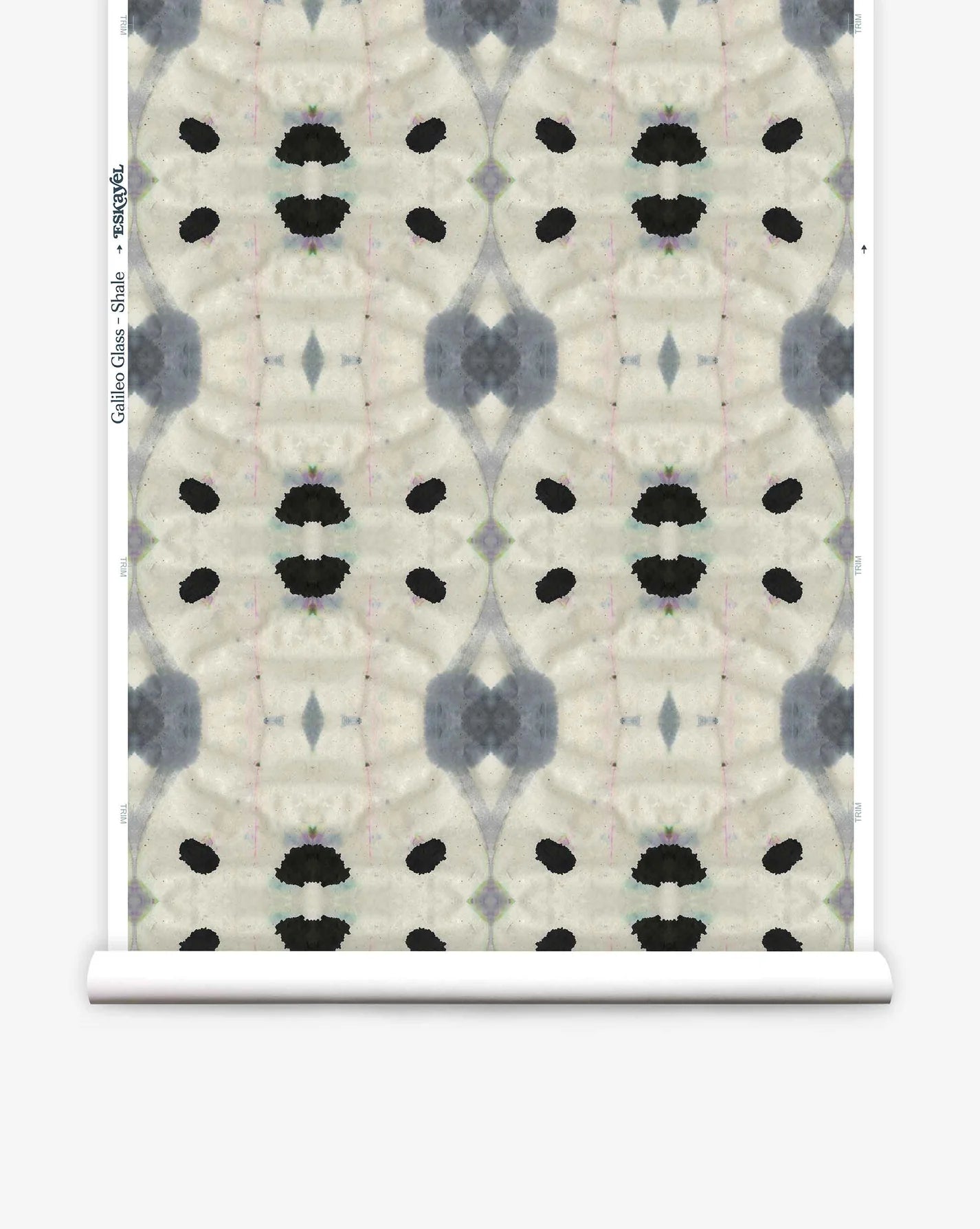 Partially unrolled wallpaper yardage in a watercolor ink blot print in shades of charcoal and black on a tan field.