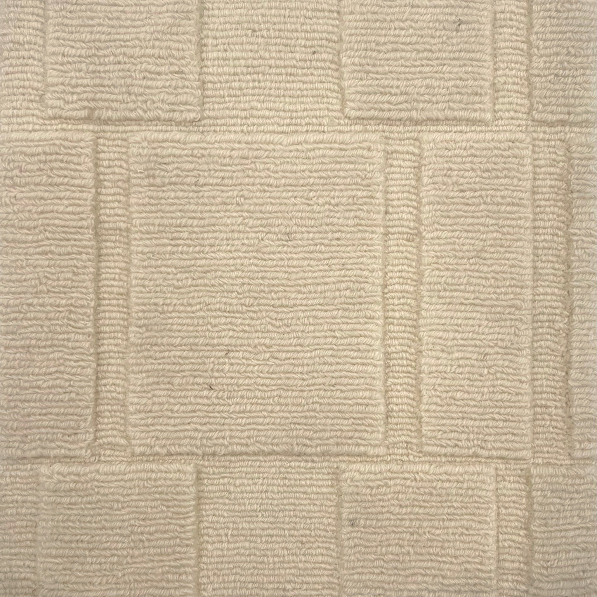 Handknotted custom rug in ivory with dimensional square pattern.