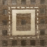 Handknotted rug in a decorative square design in sahdes of brown and cream on a taupe field