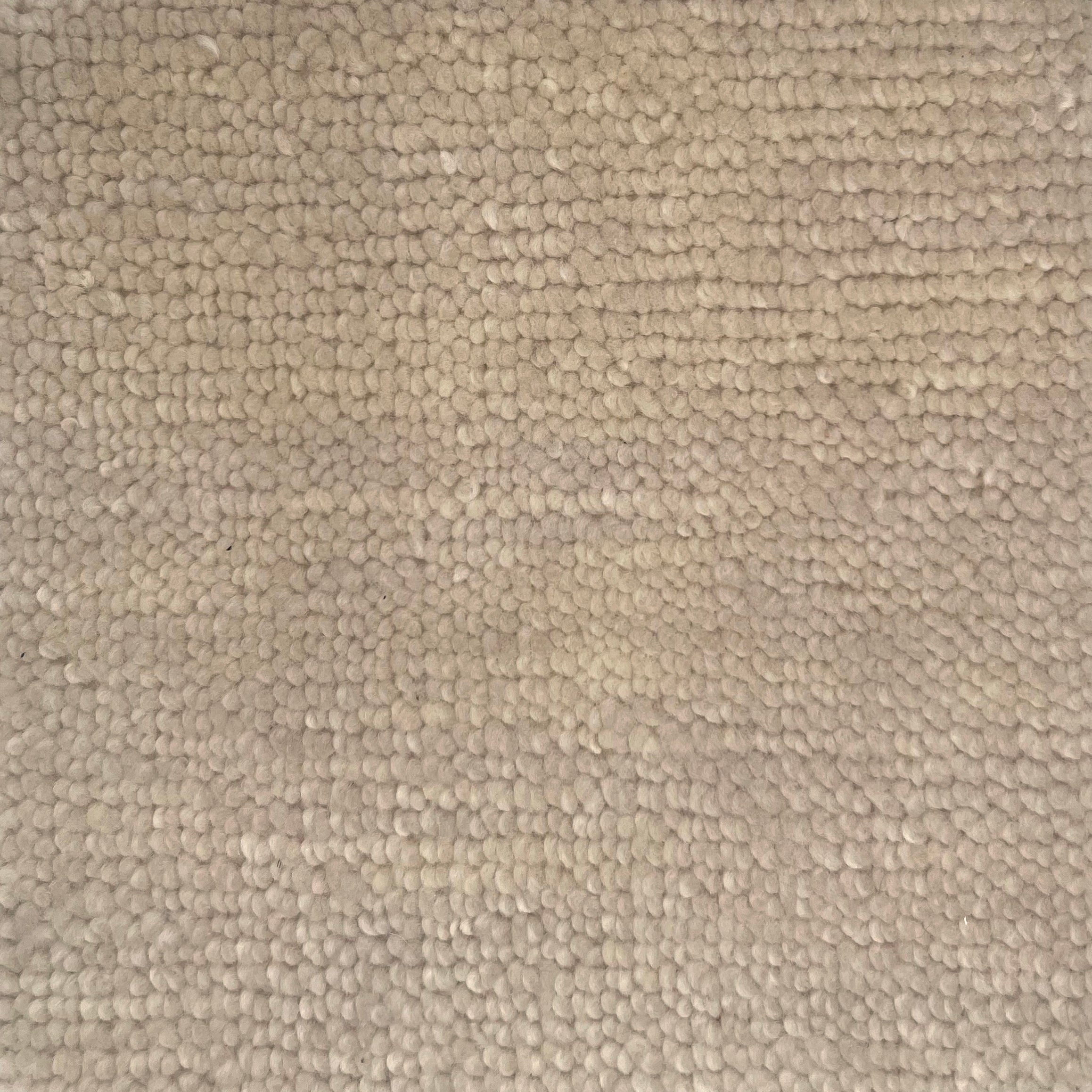 Handknotted rug in a textural loop in ivory. 