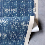 Draped yardage of printed grasscloth with ikat stripe design in blue and cream 