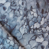 Detail draped fabric in a watercolor textural print in shades of blue, navy and black.
