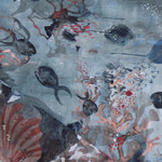 Draped fabric in an underwater sealife scene in shades of blues with red accents. 
