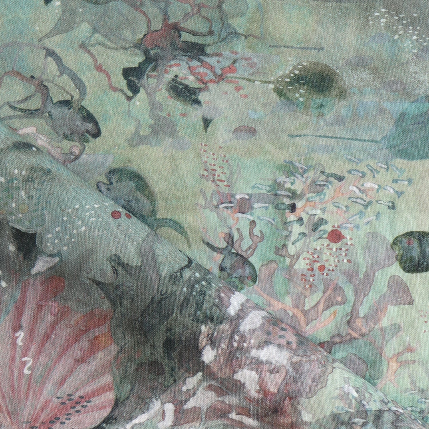 Draped fabric in an underwater sealife scene in shades of sage green with coral accents. 