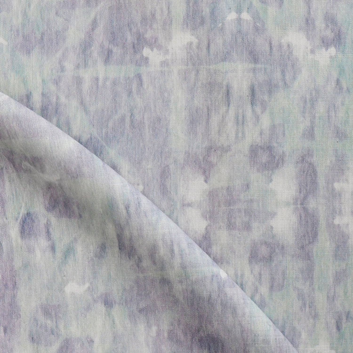 Detail of draped fabric in a watercolor dyed grid print in mottled purple and turquoise.