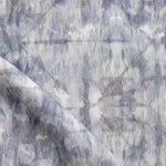 Detail of draped fabric in a watercolor dyed grid print in mottled shades of purple