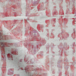 Detail of draped fabric in a watercolor dyed grid print in mottled white, pink and red.