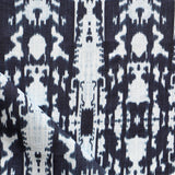 Detail of draped fabric in a painterly ikat print in blue and white.