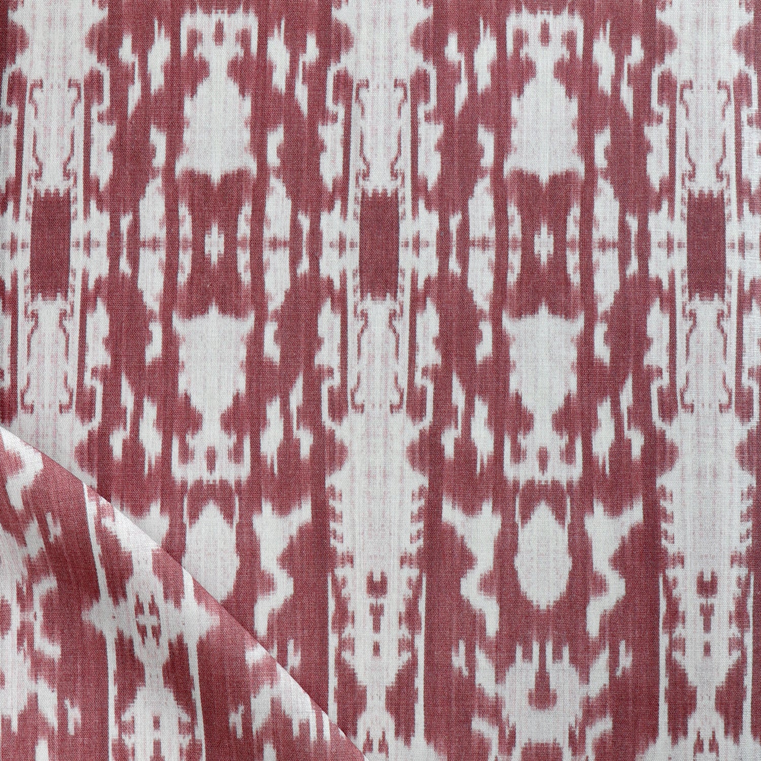 Detail of draped fabric in a painterly ikat print in rust and white.