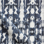 Detail of draped fabric in a painterly ikat print in navy and white.