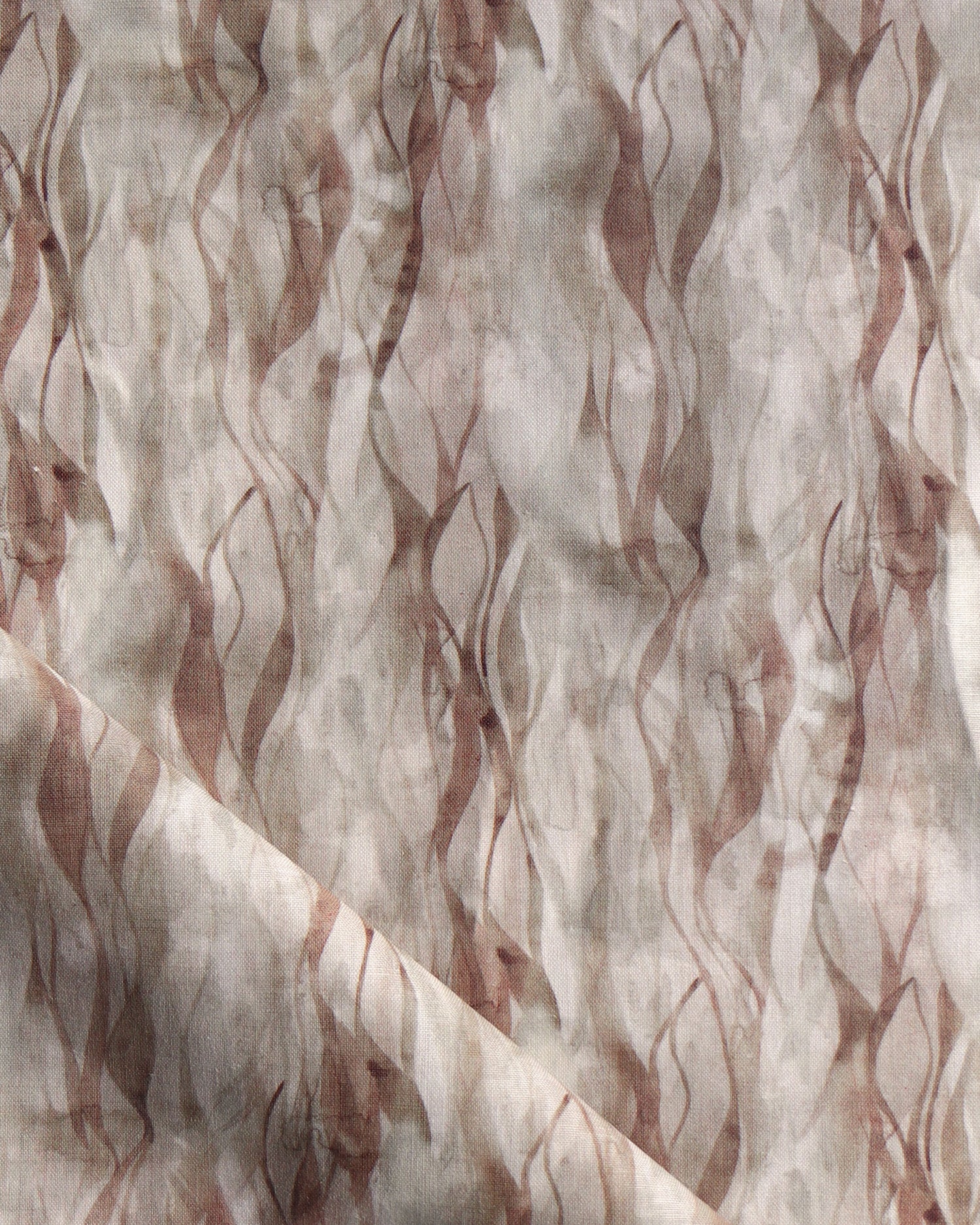 Draped fabric in a layered squiggle watercolor pattern in shades of brown