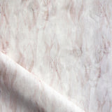 Draped fabric in a layered squiggle watercolor pattern in shades of pastel pink. 