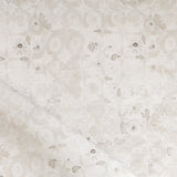 Close-up of a watercolor lace design in soft beige. 